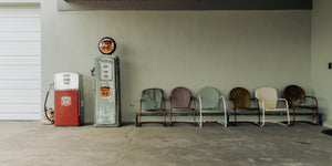 Colour photograph of old fuel pumps and weathered chairs on Route 66