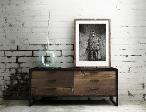 Monochrome museum display with chains and a suspended iron cage