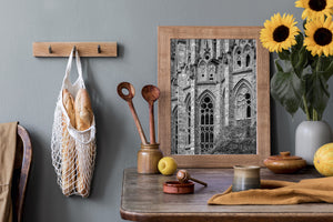 Sculpted stone facade with narrow arched openings and round window details