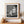 Upward view of a seated mannequin and architectural ledge
