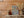 Vertical street-art detail with overlapping signatures and a small sticker