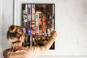 Vertical city scene with red green and blue signs after dark