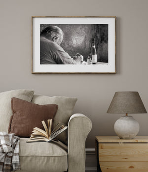 Quiet black and white restaurant scene with a seated resting figure