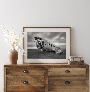 Weathered plane wreck beneath a streaked cloudy sky