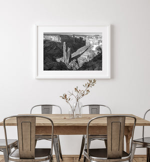 Layered canyon walls and towering sandstone formations in monochrome.