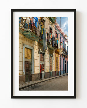 Sunlit Havana balconies with hanging laundry above a colourful Cuban street.
