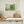 Turquoise wooden shutters set into a pale green wall with worn surface marks.