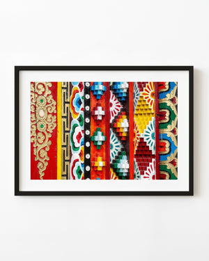 Bright Tibetan painted woodwork with raised geometric patterns in red, blue, yellow, green and gold.