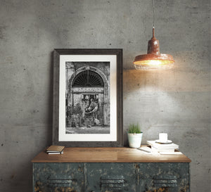 Tivoli street art framed by worn stone and a fan-shaped iron grille