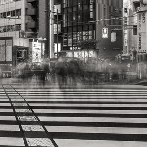 Tokyo crosswalk with ghostlike pedestrians and Japanese storefront signs