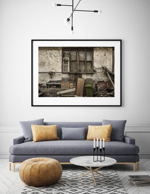 Textured plaster and exposed wooden laths on a weathered Transylvanian farmhouse.