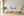 Panoramic desert scene with warm earth tones and a broad cool-toned sky