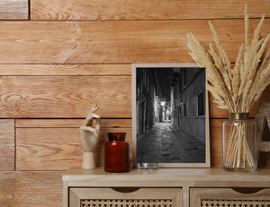 Starburst lamps illuminate a deserted alley in Venice at night