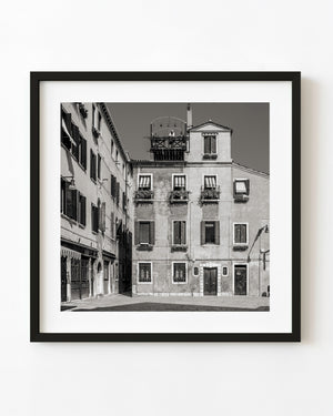 Venice buildings with shuttered windows and flower boxes in black and white