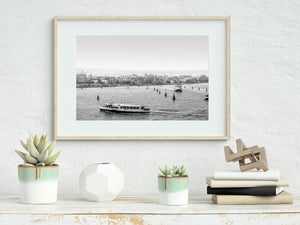 Venetian public transport boat passing distant shoreline buildings