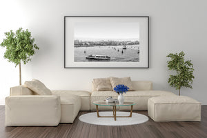 A low white waterbus travels before a long Venetian shoreline