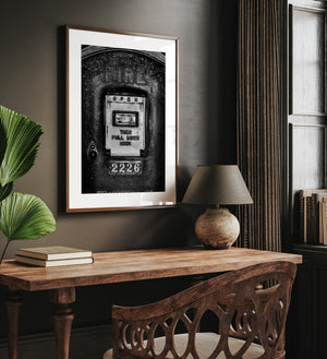 Monochrome close-up of an antique fire call box with textured metal surfaces