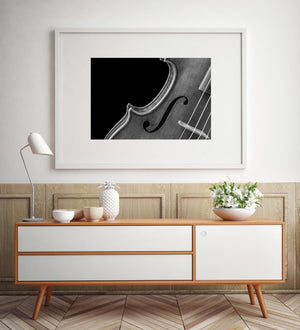 Violin body with a dark f-hole and fine wooden grain.