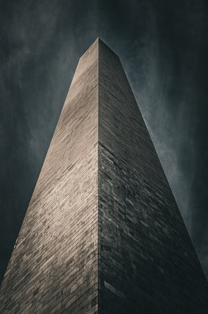 Dramatic upward perspective along the Washington Monument stone walls.