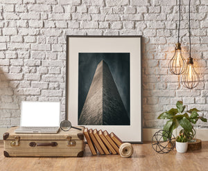 Washington Monument tapering into a moody sky above the viewer.