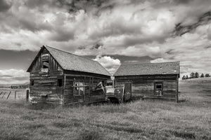 Old wooden farm buildings and machinery near Hedley, British Columbia