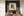 Old wooden shutters with flaking green paint and textured masonry