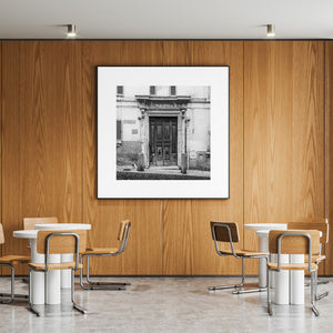 Old double door and shuttered windows in a monochrome Italian facade