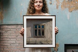Rustic Romanian architecture with an aged wooden window and textured wall