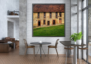 Historic French building detail with warm stonework, red bricks and worn timber