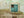 Old turquoise wooden shutters and textured wall in Romania