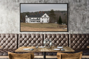 Quiet Maine countryside with a white house and pale spring grass