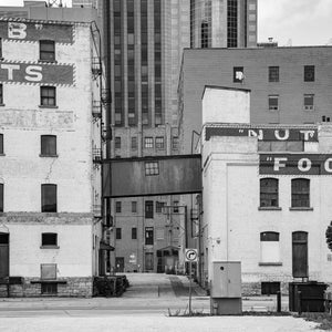 Historic brick warehouses connected by a raised walkway in Winnipeg
