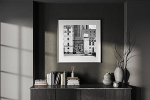 Monochrome architectural photograph of an alley between old warehouse buildings
