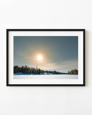 Winter sun above a frozen lake in Northern Ontario
