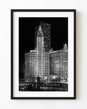 Wrigley Building clock tower illuminated at night in black and white