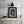 Dark timber beams cross above shelves of household objects in Matsue, Japan.