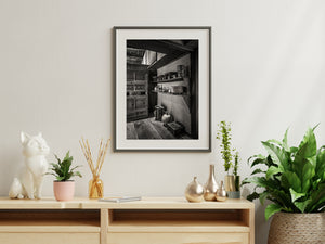 Black and white still life of household vessels against a textured wall in a Japanese samurai residence.