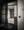 A pale fusuma panel with a metal pull stands beside an open Japanese doorway.