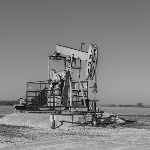 Black and white photograph of a weathered Ontario oil pumpjack