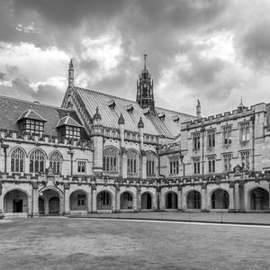 University of Sydney stone courtyard beneath a cloudy sky in black and white