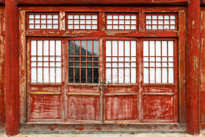 Red painted wooden doors with lattice windows at the Great Wall of China