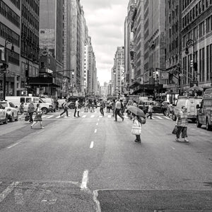 Black and white Manhattan street scene with pedestrians, traffic and tall buildings